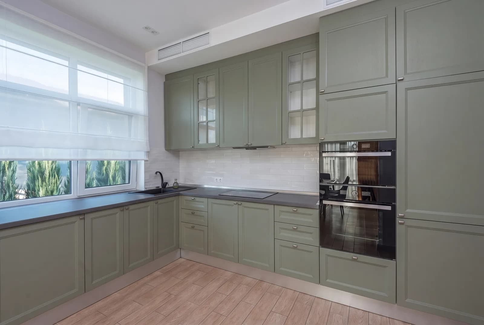 Kitchen cabinets rendered in Sherwin-Williams Dried Thyme SW 6186, tile, counters and floor unchanged