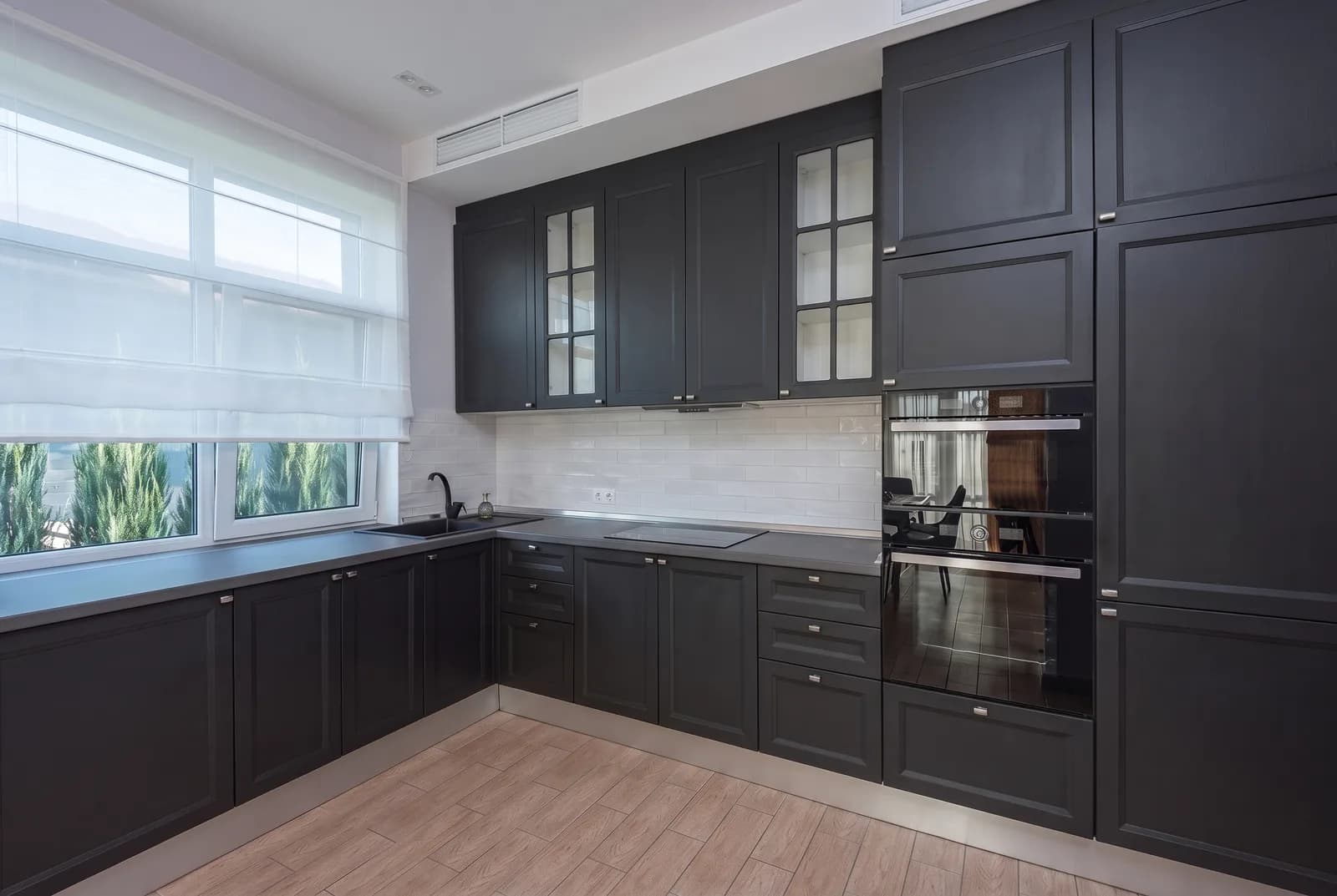 Kitchen cabinets rendered in Sherwin-Williams Tricorn Black SW 6258, tile, counters and floor unchanged