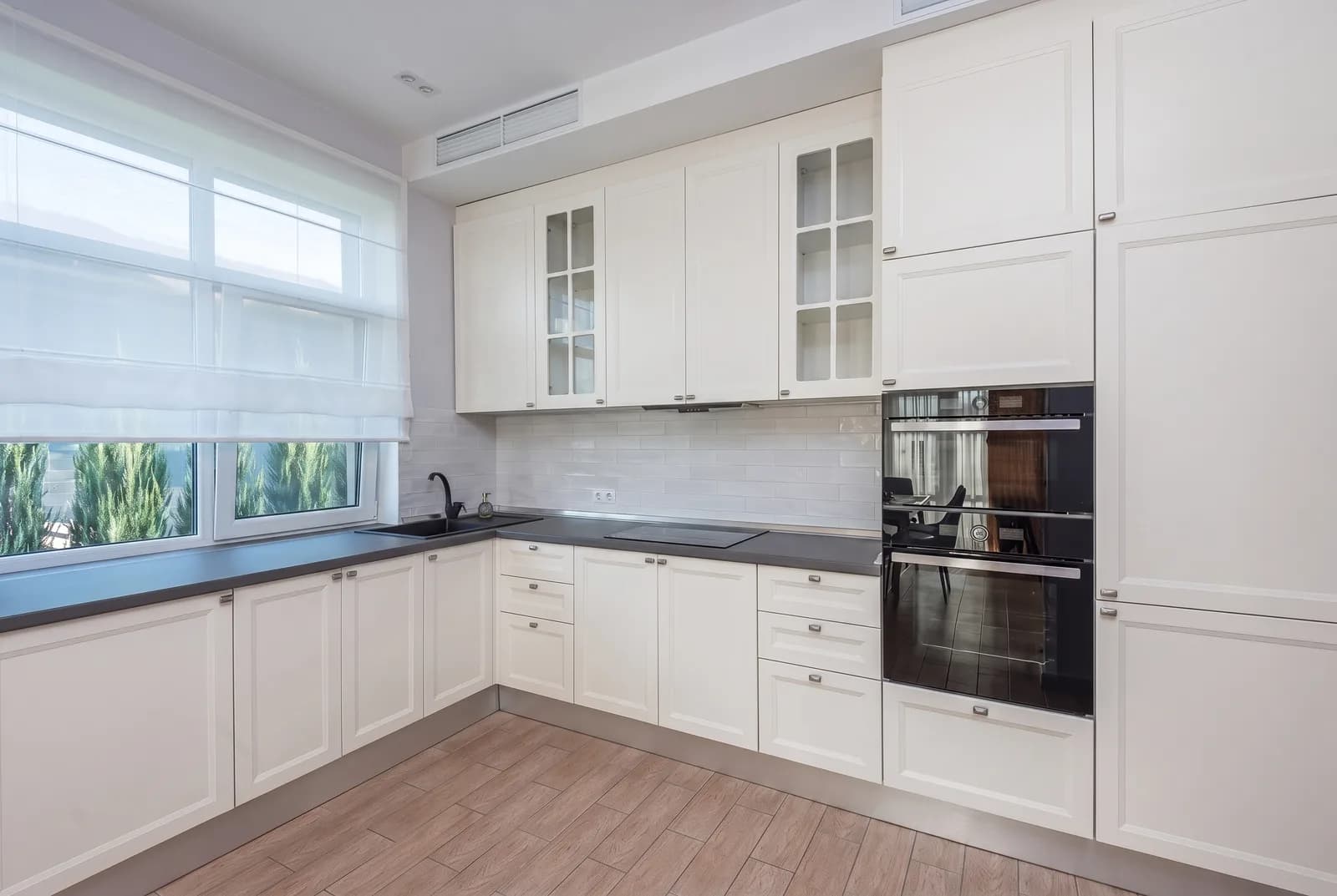 Kitchen cabinets rendered in Sherwin-Williams Snowbound SW 7004, tile, counters and floor unchanged