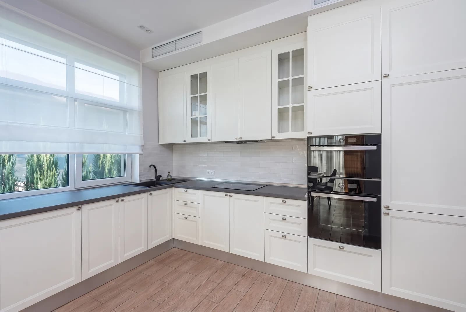 Kitchen cabinets rendered in Sherwin-Williams Extra White SW 7006, tile, counters and floor unchanged