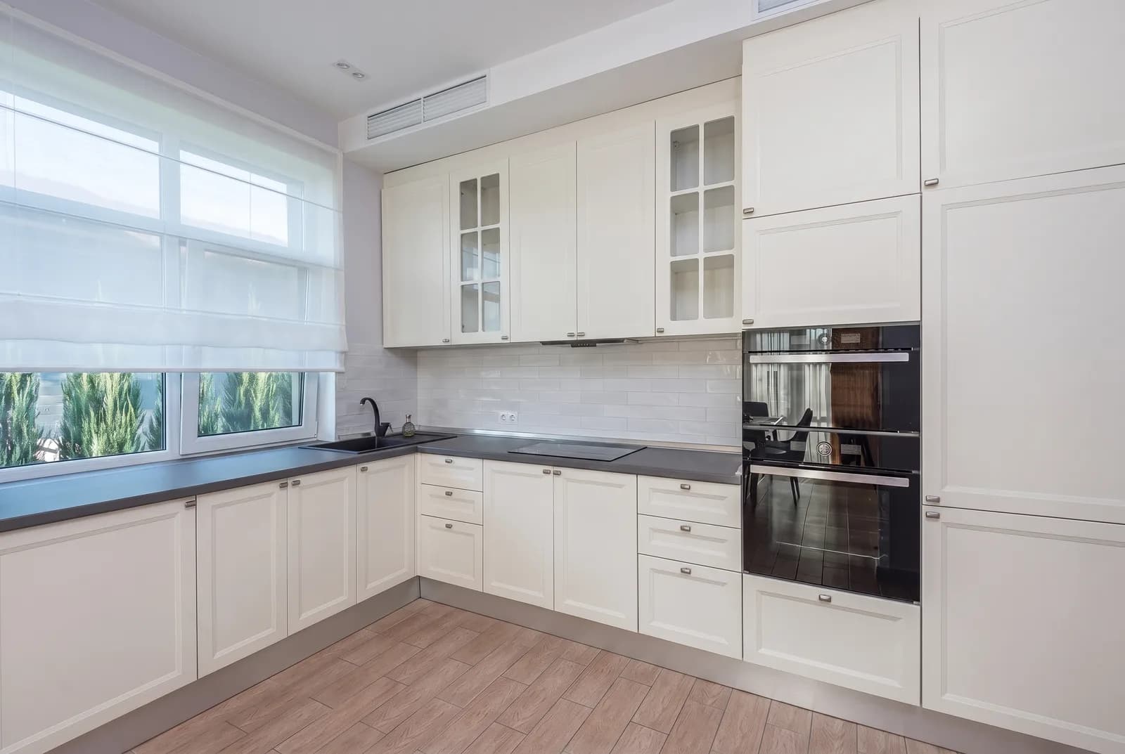 Kitchen cabinets rendered in Sherwin-Williams Alabaster SW 7008, tile, counters and floor unchanged