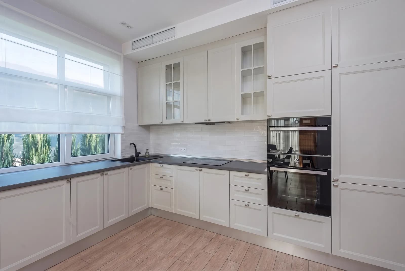 Kitchen cabinets rendered in Sherwin-Williams Repose Gray SW 7015, tile, counters and floor unchanged