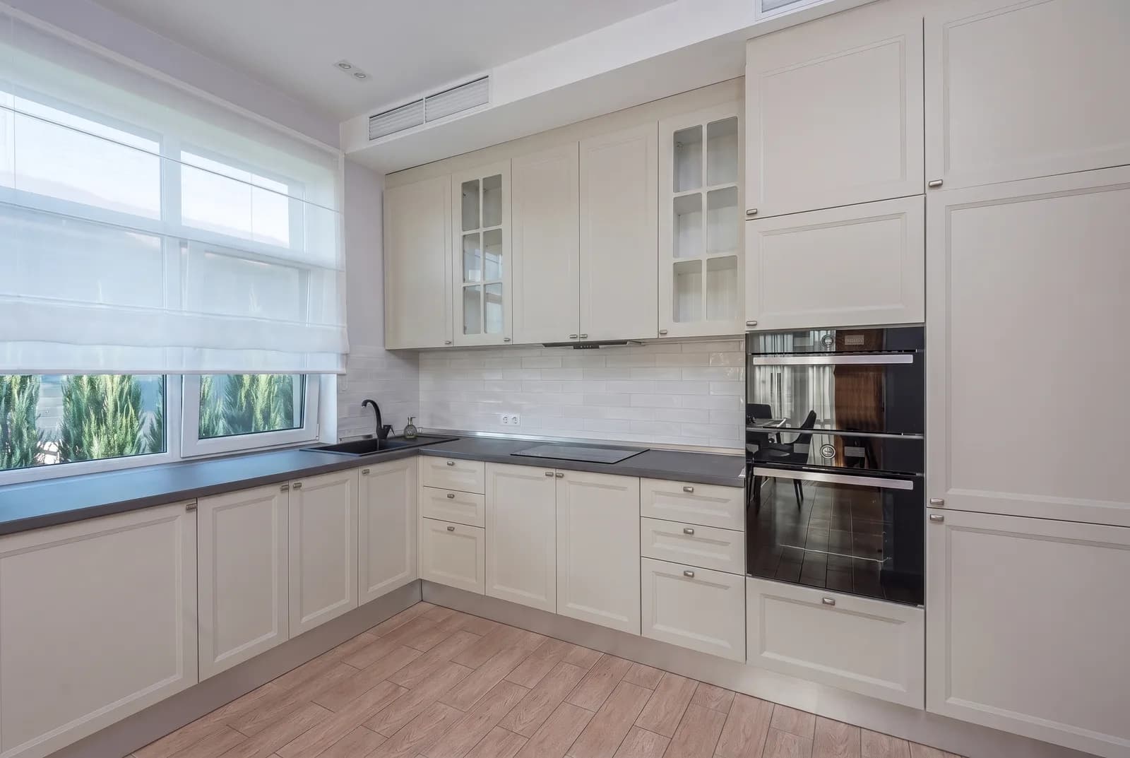 Kitchen cabinets rendered in Sherwin-Williams Agreeable Gray SW 7029, tile, counters and floor unchanged