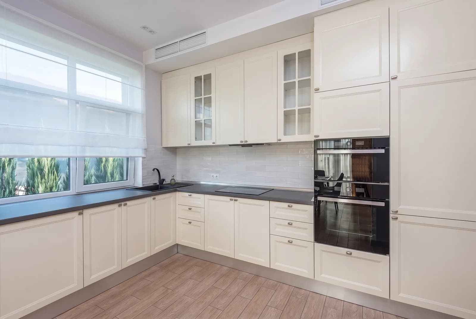 Kitchen cabinets rendered in Sherwin-Williams Shoji White SW 7042, tile, counters and floor unchanged