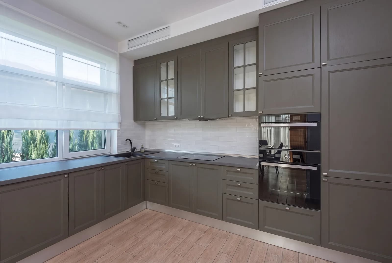 Kitchen cabinets rendered in Sherwin-Williams Urbane Bronze SW 7048, tile, counters and floor unchanged
