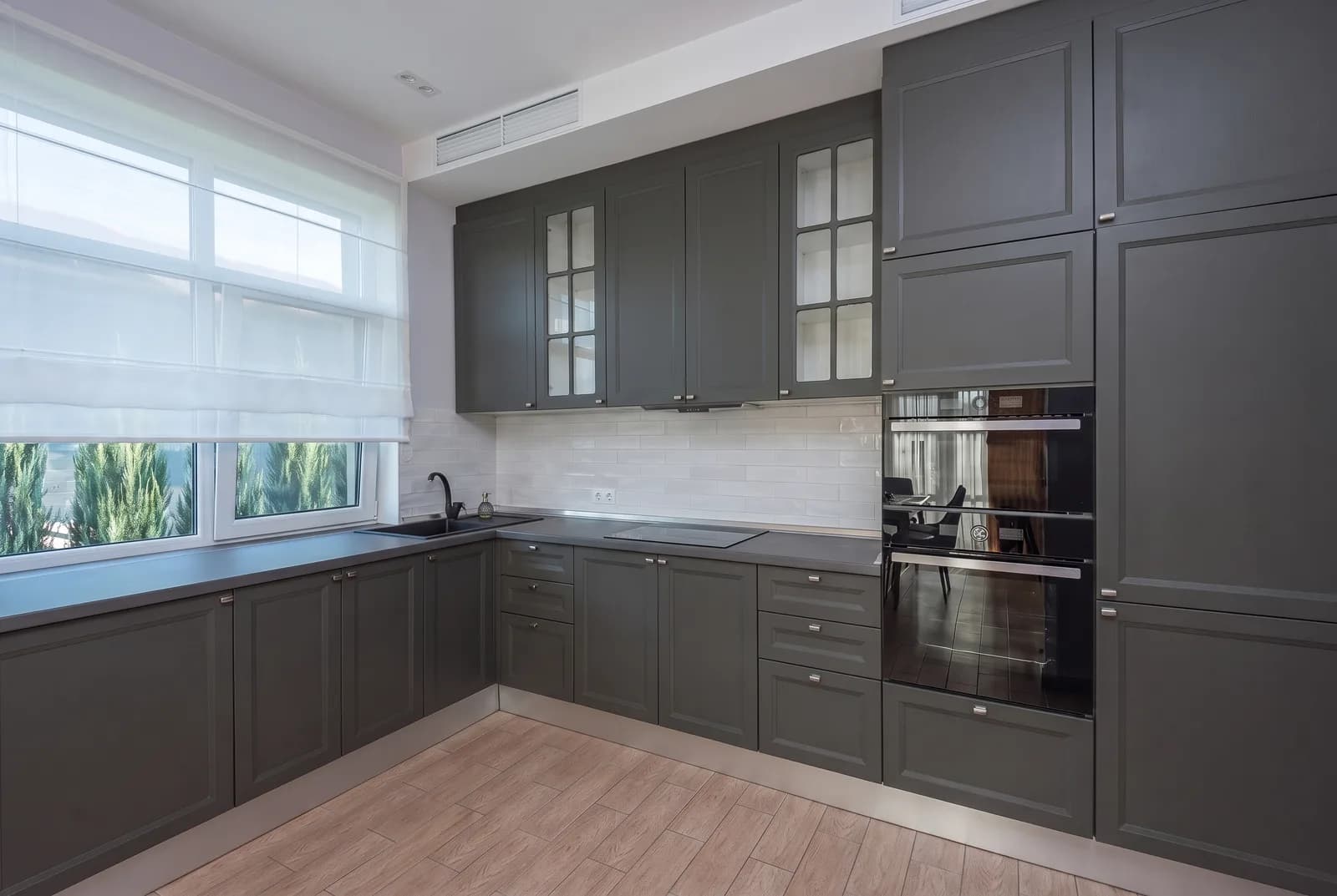 Kitchen cabinets rendered in Sherwin-Williams Iron Ore SW 7069, tile, counters and floor unchanged