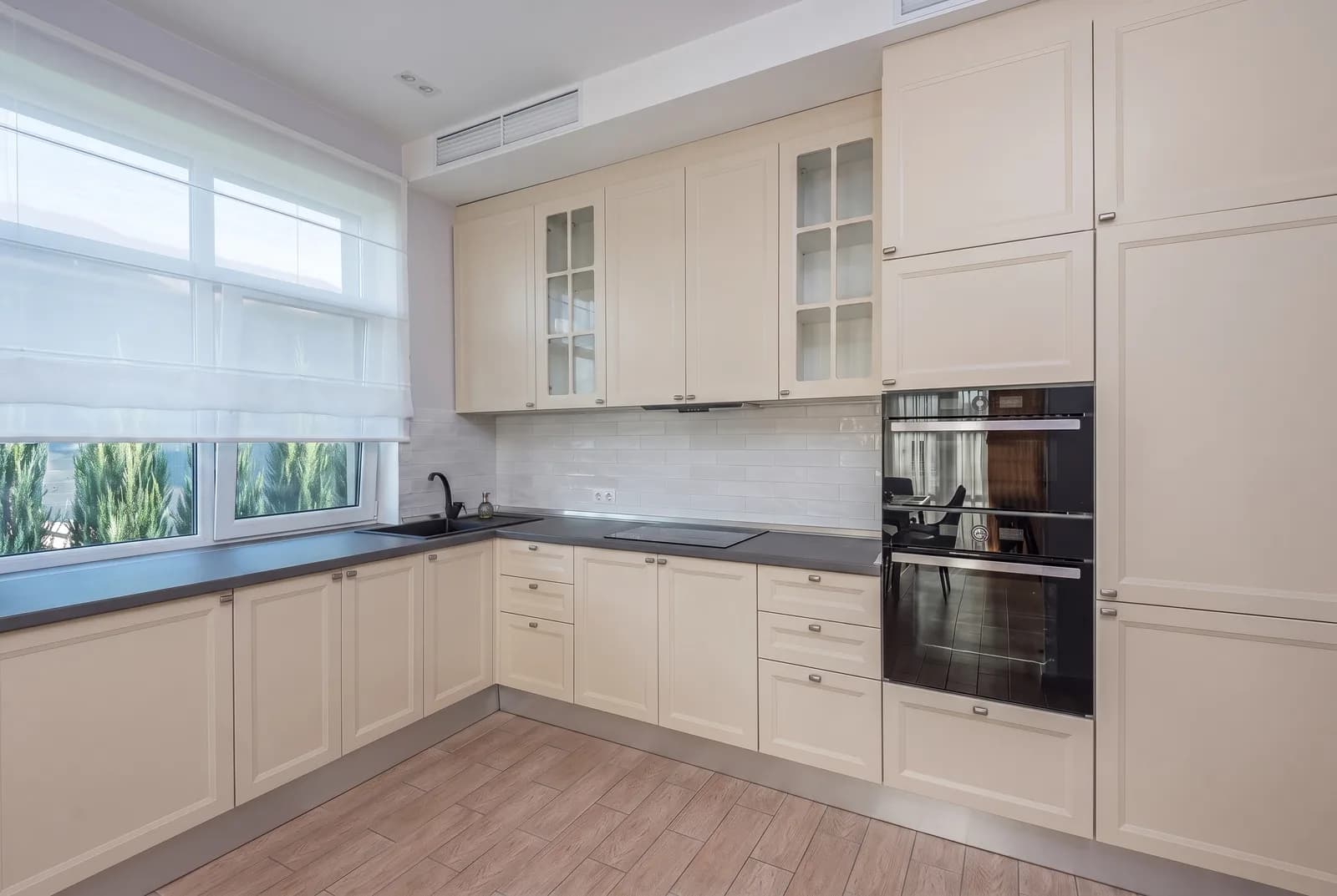 Kitchen cabinets rendered in Sherwin-Williams Natural Linen SW 9109, tile, counters and floor unchanged